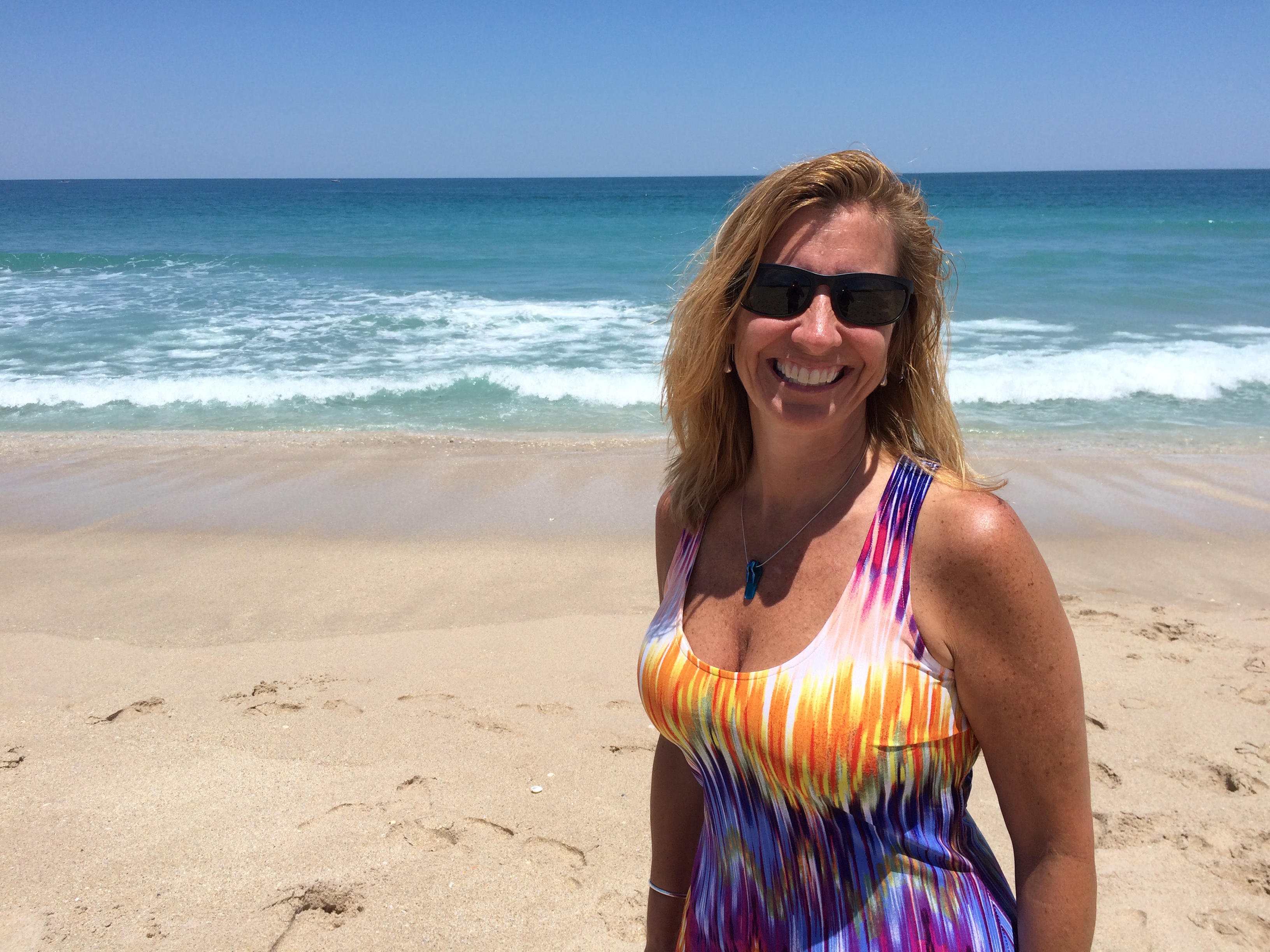 Sexy girl walking on beach with a cold Michelob Ultra